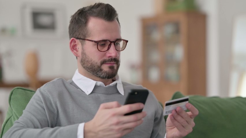 Middle Aged Man making Online Payment on Smartphone 