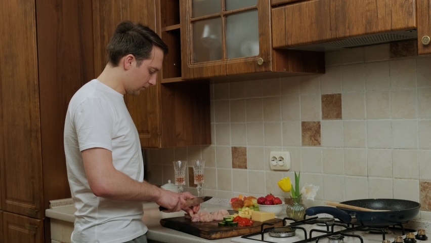 Young man that prepares food in the kitchen to his lovely wife, having fun and enjoy the moment, anniversaries and St Valentine