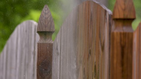 Pressure Wash Slow Motion Wood Fence Side Close Up. Water Spray in slow motion from pressure washing the outside of a wood fence