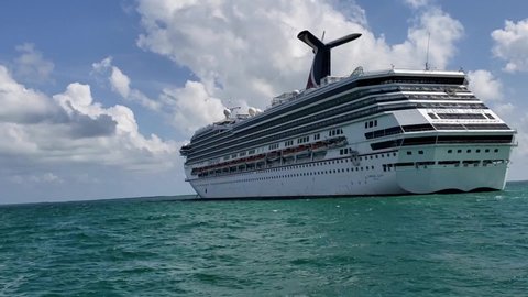 Hyperlapse footage of going around the Carnival cruise line ship view from ferry boat. Carnival Cruise line, Carnival Glory, Caribbean sea, January 22, 2021