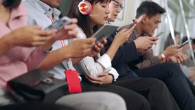 Young people using mobile phone in public underground train . Urban city lifestyle and commuting in Asia concept . - Powered by Shutterstock - Get 15% off with code: PIKWIZARD15