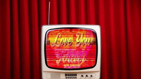 Vintage i love you message showing on television screen against a red velvet background 