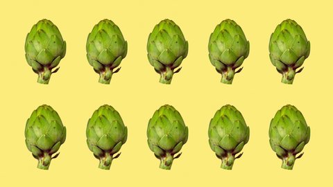 Animated rows of fresh green artichoke turning against a yellow background