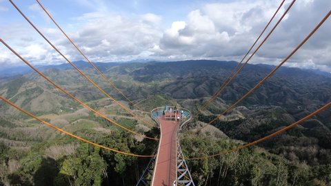 Betong, Thailand,Dec 16, 2020: (Timelapse)Beautiful top view at Ai Yerweng Skywalk in Yala province, the longest skywalk in Asia. Tourists visit the landmark above the forest .