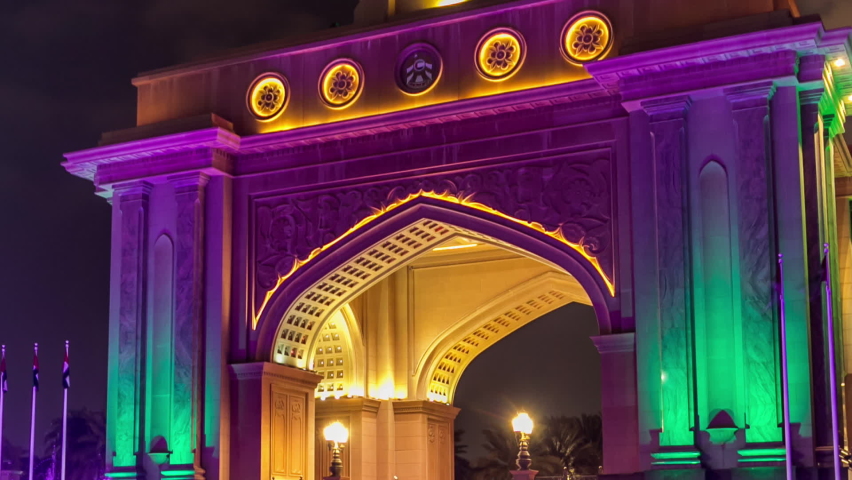 Colorful fountain at the gate to Emirates Palace night timelapse, UAE. Five stars Emirates Palace is the second most expensive hotel ever built