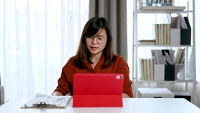 Asian businesswoman work at home and virtual video conference meeting with colleagues business people, online working, video call due to social distancing at home office.