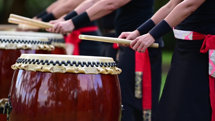 Group of Taiko drummers drumming on Japanese Drums together out door.Real people. Copy space Royalty-Free Stock Footage #1066294744