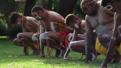 PERTH - JAN 26 2021:Aboriginal Australian men preforming a traditional on Australia Day celebrations.Australian Aboriginal dance often imitated the Australian animals behaviour.