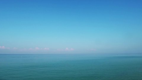 4k cinemagraphs b-roll TimeLapse. Colorful pastel purple pink calm seawater surface n cyan green ocean wave ripple on morning sunrise clear blue sky background with white cumulus cloud n cloudscape.