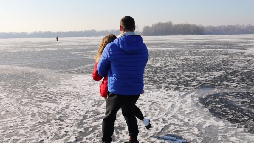 Couple In A Winter Forest And Frozen Lake.