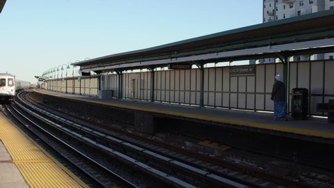 Queens, New York,USA - November 1. 2019: MTA Subway Train entering station. A Train in New York Elevated Station. Far Rockaway Subway station