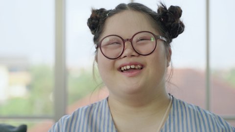 Portrait, girl with Down syndrome laughing