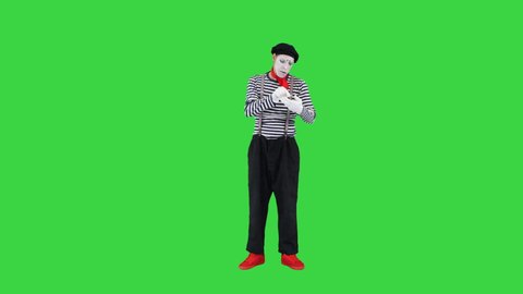 Mime talking on imaginary phone on a Green Screen, Chroma Key.