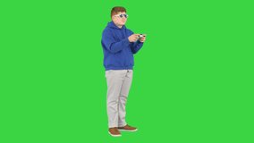Teenager actively playing video game on a Green Screen, Chroma Key.