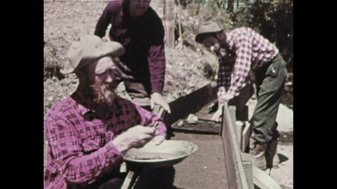 1960s: Men panning for gold, look at nugget. Map of western United States, label appears. Horses pulling stagecoach. Hnad typing on telegraph. Man riding horseback.