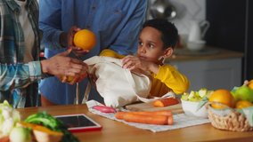 Close-up of african family unpacking shopping bug purchasing nutritonal foods making dinner together. Ethnicity. Parenthood. Healthy food. - Powered by Shutterstock - Get 15% off with code: PIKWIZARD15