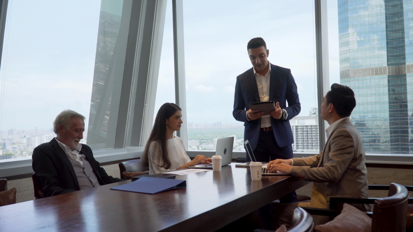 Group of business People Meeting  in office on window . marketing team Conference Brainstorming. manager man standing and present . Financial Teamwork discussing strategy at workspace on cityscape  | Shutterstock HD Video #1066317574