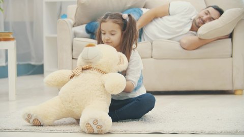 daughter playing while drunk dad sleeping Stock Footage Video (100%