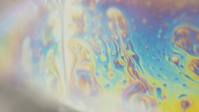 large soap bubbles and multi-colored patterns, reflected in bubbles, close-up.