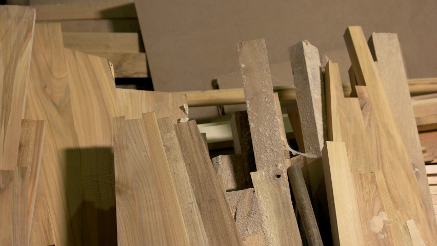 Close up of planks of wood at joinery. Background of wooden boards. Wood construction material. Wood processing at manufacture.