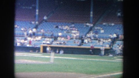 YANKEE STADIUM NEW YORK-1964: Baseball Pitcher Throws A Pitch To The Batter In A Stadium That Is Half Filled With Fans