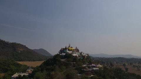 Simalai Songtham Temple, Khao Yai, Nakhon Ratchasima, Thailand; descending aerial 4K footage overlooking scenic view of Khao Yai and Luang Pu Thuat and then the sky as its background.