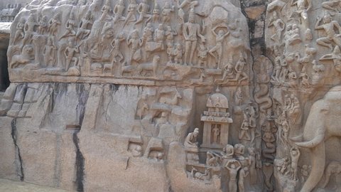 Bas relief monolithic stone carvings of God, Human and Elephant sculptures carved in the granite rocks in Mahabalipuram, Tamilnadu, India. Ancient historical stone carved sculptures.