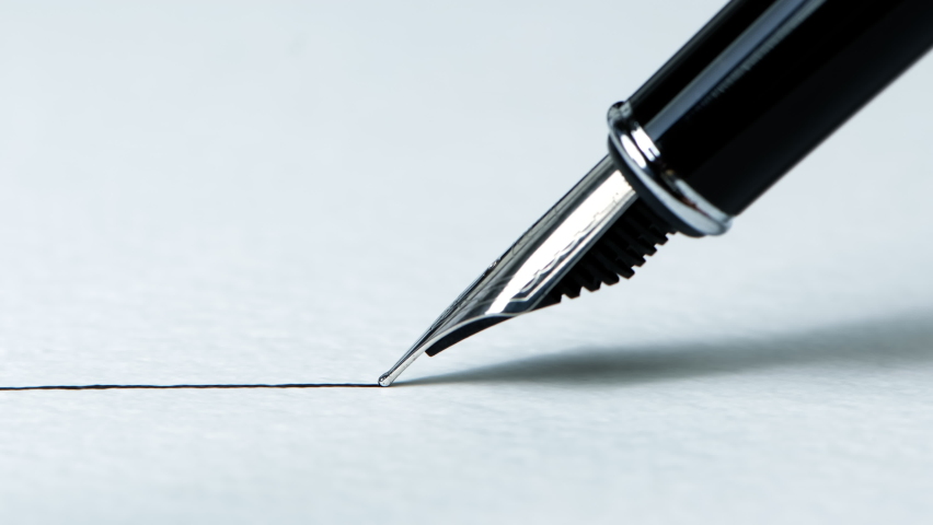 Closeup view of a fountain pen drawing a straight ink line on a textured paper surface Royalty-Free Stock Footage #1066342933