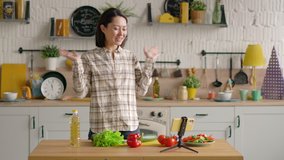 Happy mixed race female blogger making video lesson and tutorial for internet vlog website classes, smiling happy asian woman prepare healthy vegan meal, record lifestyle blog doing videochat at home