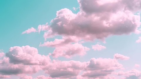 Motions clouds. Puffy fluffy beautiful pink clouds on turquise sky time lapse. Slow moving clouds. Pastel palette