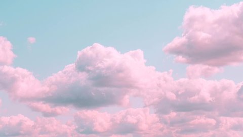 Motions clouds. Puffy fluffy beautiful pink clouds on turquise sky time lapse. Slow moving clouds. Pastel palette. Fantasy concept