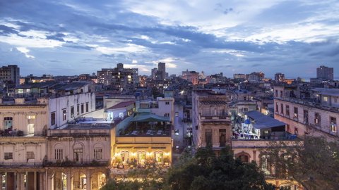 Scenic sunset time lapse with Havana cityscape, Cuba island view. Clouds over world famous historic buildings with beautiful architecture. Light in windows where people living, night scene. Travel 4K.