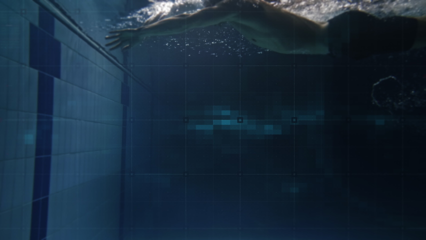 Cinematic shot of young professional male swimmer practicing with latest innovative technology augmented reality holograms underwater in swimming pool. Concept of sport, fitness, immersive technology. Royalty-Free Stock Footage #1066354627