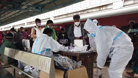 Mumbai, Maharashtra, India - January 18, 2021: Brihanmumbai Municipal Corporation (BMC) health workers screening passengers arriving in Mumbai for COVID-19 symptoms at Dadar Railway station. 