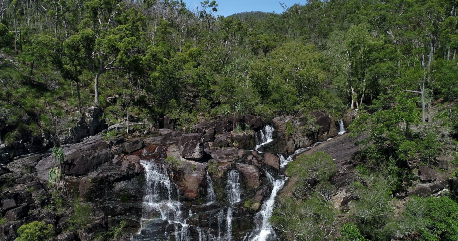 4K high reverse tracking aerial view of Cedar Creek Waterfall in good flow, Cedar Creek Falls is situated between Proserpine and the town of Airlie Beach. proserpine,Queensland,Australia