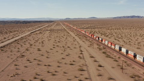 December 2020, Mojave desert, California: Aerial drone shot of cargo train passing trough the desert. 