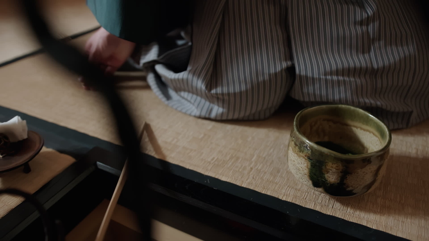 Cultural heritage of Japan: traditional Japanese tea ceremony. Tea master mixing matcha tea in chawan bowl with the use of special tools: chasen, chashaku, Chaki. One of the practices of Zen Buddhism Royalty-Free Stock Footage #1066369582
