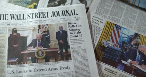 New York, New York  United States - January 21,  2021: Newspaper coverage of Joe Biden's Inauguration as 46th President of the United States. Biden signs first executive orders in Oval Office.