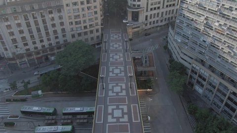 Iconic Viaduto Santa ifigenia in downtown Sao Paulo empty due to quarantine restrictions. Aerial 4K Drone tracking shot from above in late afternoon light during recent lockdown in the city.