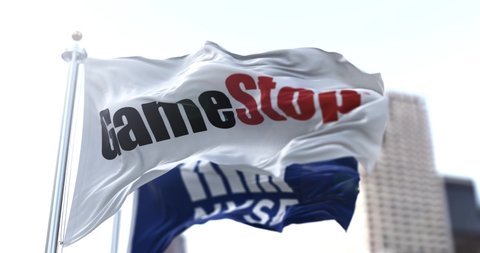 New York, USA, January 28, 2021: Flags of Gamestop and the NYSE waving in the wind. On January 28, 2021, GameStop's short squeeze raised the share price nearly 900 times in NYSE stock exchanges