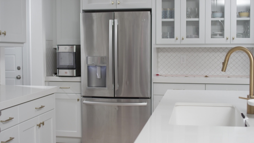 Refrigerator in clean white modern kitchen. Home appliance beauty shot dolly Royalty-Free Stock Footage #1066389358