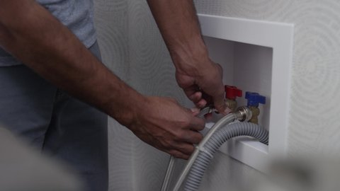 Disconnecting the water supply to a washing machine before moving or repair