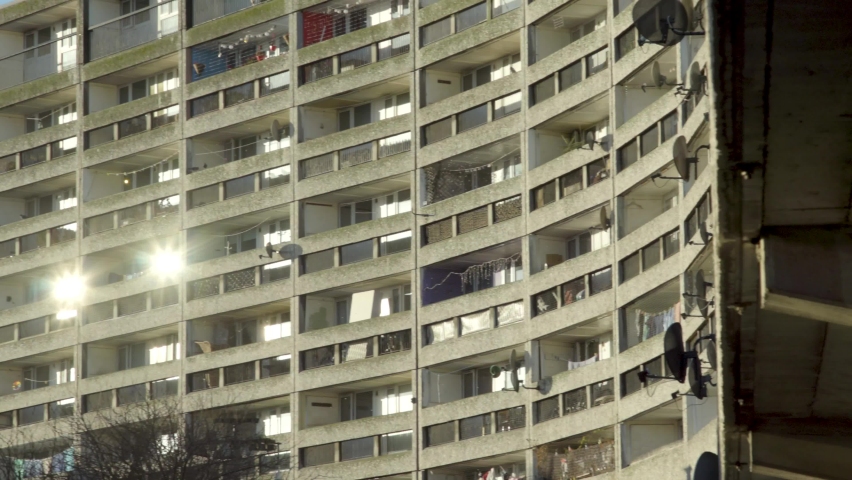 Panning shot of urban brutalist architecture block of flats with social housing