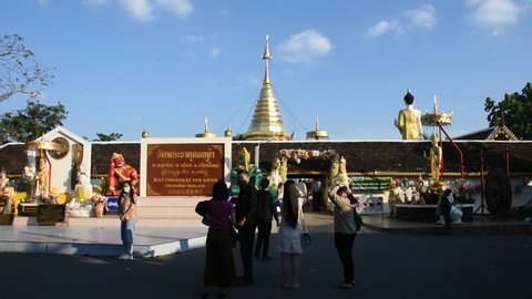 Thai people and foreign travelers travel visit respect praying buddha god angel deity of Wat Phra That Doi Kham or Temple of the Golden Mountain at Mae Hia on November 10, 2020 in Chiang Mai, Thailand