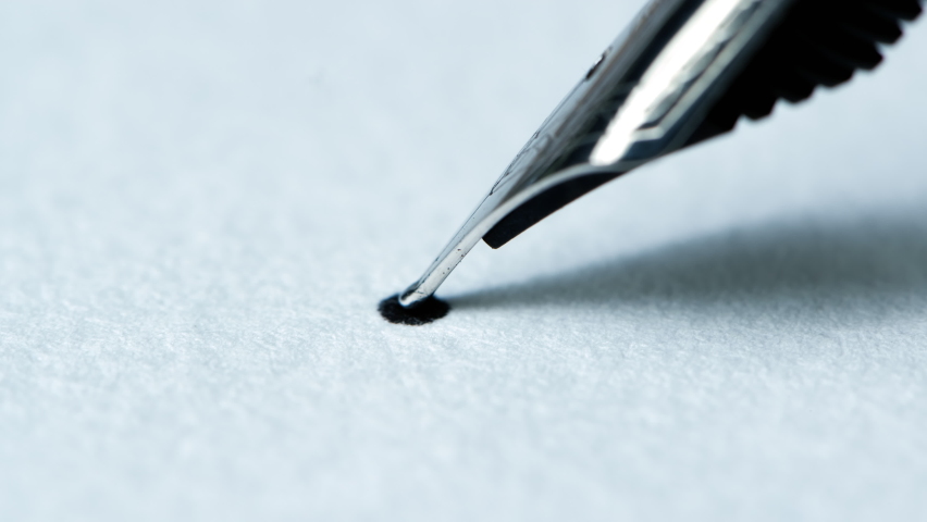 Ink from fountain pen spreading on white paper. Royalty-Free Stock Footage #1066399111