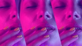 High Fashion model girl in colorful bright UV lights posing, portrait of beautiful woman with trendy make-up and manicure. Сolorful face make up. Over colourful purple background. Slow motion