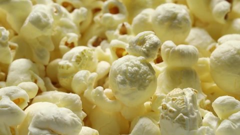 Tasty group of white popped salted popcorn full frame close up 
