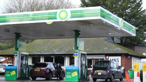READING, UK - JANUARY 28, 2021: People using pumps to fill their vehicles with fuel at a BP petrol station in Reading, Berkshire, UK.