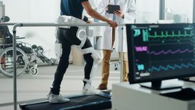 Modern Hospital Physical Therapy: Doctor Uses Tablet Computer, Disabled Patient Walks on Treadmill Wearing Advanced Robotic Exoskeleton. Computer Monitor Shows Physiotherapy Rehabilitation Activity - Powered by Shutterstock - Get 15% off with code: PIKWIZARD15