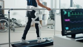 Modern Hospital Physical Therapy: Patient with Injury Walks on Treadmill Wearing Advanced Robotic Exoskeleton Legs. Physiotherapy Rehabilitation Technology to Make Disabled Person Walk. Focus on Legs - Powered by Shutterstock - Get 15% off with code: PIKWIZARD15